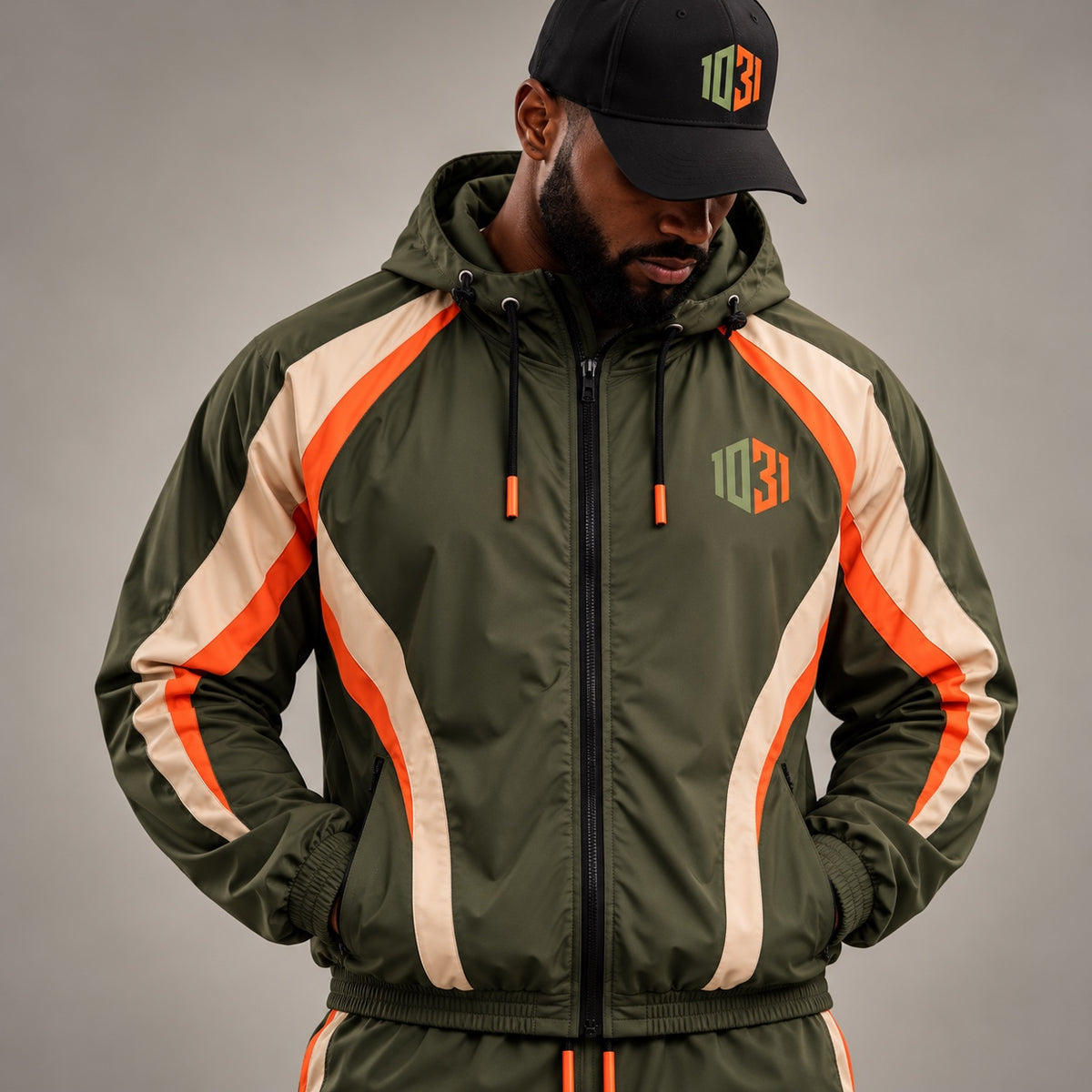 Model wearing the 1031 Athletics olive, cream, and orange lightweight training jacket